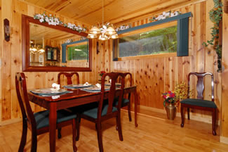 Dining room is close to the main door and living room. When you walk in the cabin there is a dining room to the right and the living room featured to the left